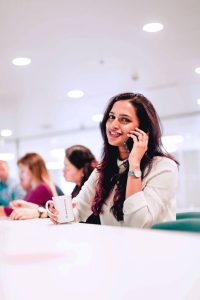 Woman holding her phone in a coworking space