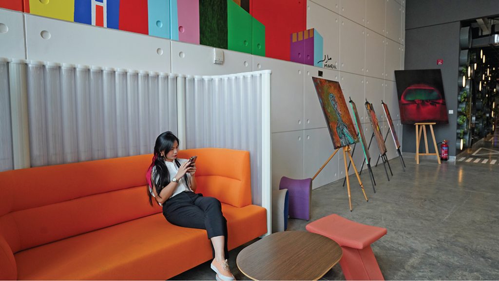 A woman using her mobile phone in a coworking space